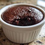 A rich, fudgy Cottage Cheese Microwave Brownie baked in a white, fluted ramekin.