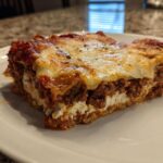 A thick, layered slice of Lasagna with Cottage Cheese showing rich meat sauce and melted cheese topping.