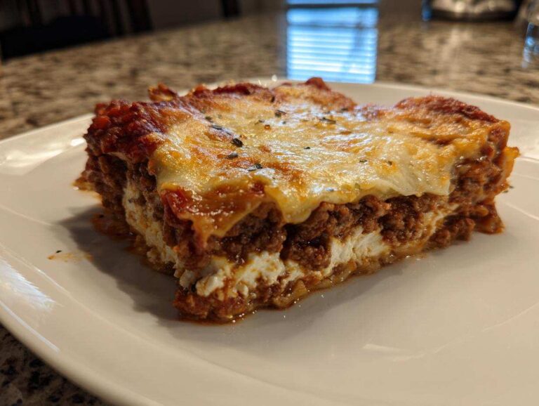 A thick, layered slice of Lasagna with Cottage Cheese showing rich meat sauce and melted cheese topping.