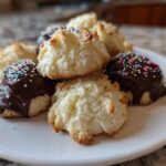 A pile of fluffy Italian butter cookies, some dipped in chocolate and covered with colorful sprinkles.