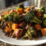 Close-up of a veggie lentil salad featuring brown lentils, roasted sweet potatoes, and charred broccoli florets.