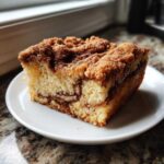 A moist slice of Gluten-Free Cinnamon Sugar Coffee Cake with a thick cinnamon streusel topping.