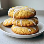 A stack of three delicious Gluten-Free Lemon Ricotta Cookies topped with white glaze and lemon zest.