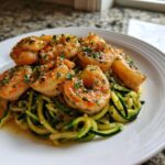 Plump shrimp coated in garlic butter and herbs served over a bed of Keto Shrimp Scampi Zucchini Noodles.