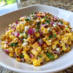 Close-up of vibrant Copycat Mexican Grill Corn Salsa featuring charred corn, red onion, cotija cheese, and cilantro.
