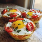 Three perfectly cooked Easy 5-Minute Microwave Egg Caprese Cups topped with bright yolks, tomatoes, and basil.