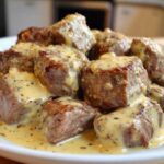 Close-up of seared steak bites smothered in a creamy garlic sauce, the main feature of Easy One-Pan Creamy Garlic Steak Bites.