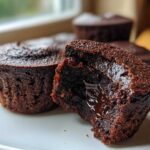 Close-up of a Gluten-Free Chocolate Lava Brownie Cup broken open to show the gooey, molten chocolate center.