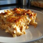 A close-up serving of Keto Creamy Buffalo Chicken Casserole with a golden, bubbly cheese topping.
