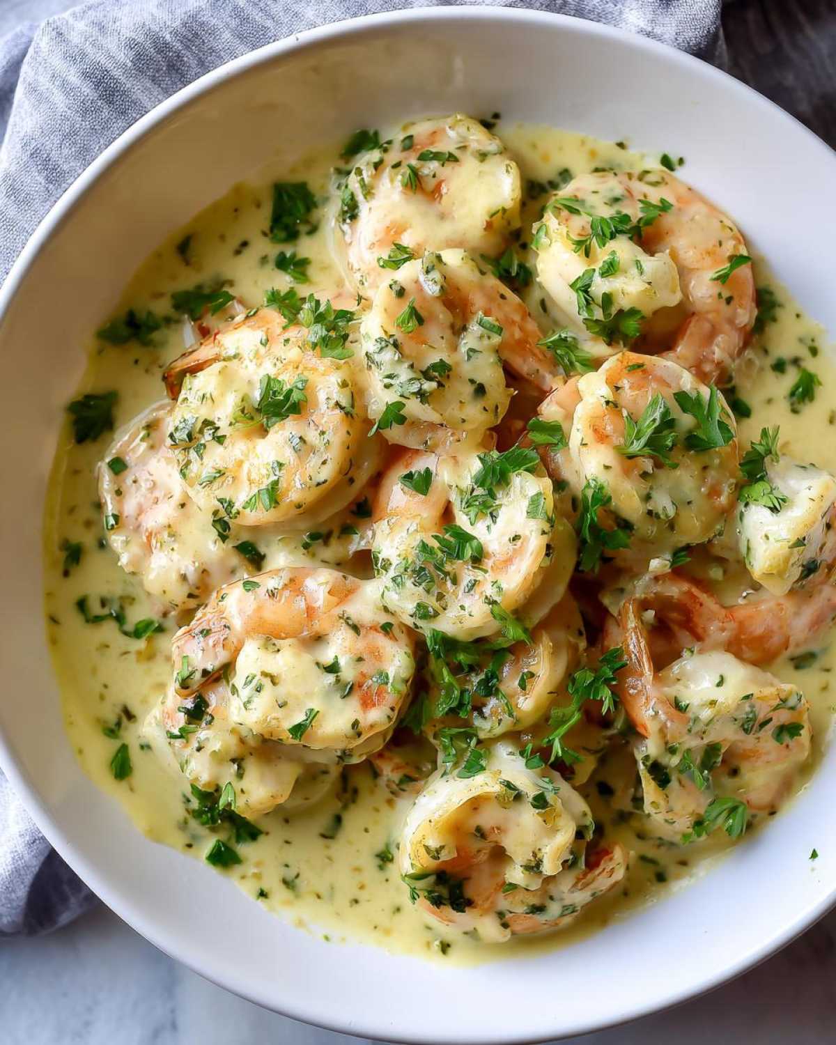 Close-up of Keto Creamy Garlic Shrimp Skillet, featuring plump shrimp coated in a rich, creamy garlic sauce and topped with fresh parsley.