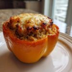 A single, perfectly baked Keto Creamy Italian Sausage Stuffed Pepper with a golden, melted cheese topping.