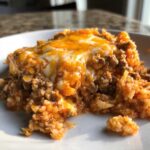 A close-up serving of Keto Creamy Taco Skillet with Cauliflower Rice topped with melted cheddar and Monterey Jack cheese.