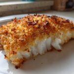 Close-up of a flaky white cod fillet with a golden brown, crispy Keto Crispy Parmesan Crusted Cod topping.