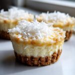 A close-up of one of the No-Bake Lemon Coconut Cheesecake Cups topped with shredded coconut.