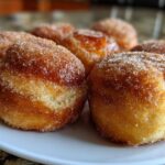 Close-up of several golden-brown Cinnamon Donut Bread Pull Apart pieces coated generously in sparkling cinnamon sugar.