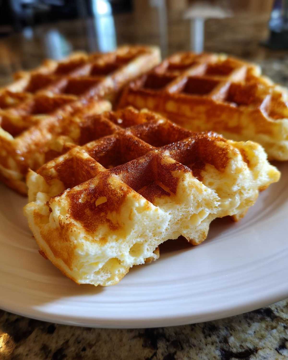 Close-up of a fluffy Belgian waffle showing its airy interior texture, made from the best batter.