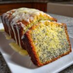 Close-up of a Moist Lemon Poppy Seed Loaf, sliced and drizzled with a thick, zesty lemon glaze.